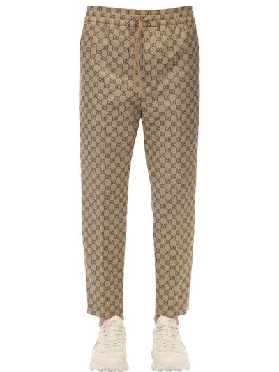 pantaloni gucci uomo beige|Pantalone in tessuto GG con GG in pelle in beige e blu .